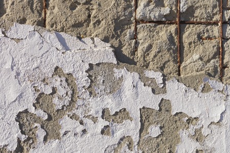 Texture of old stucco wall. Dumps paint and plaster, rusty fixtures. Bright sunlightの写真素材