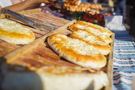 Bread baked tortilla with cheese and spices. Street food on a wooden bakingの写真素材
