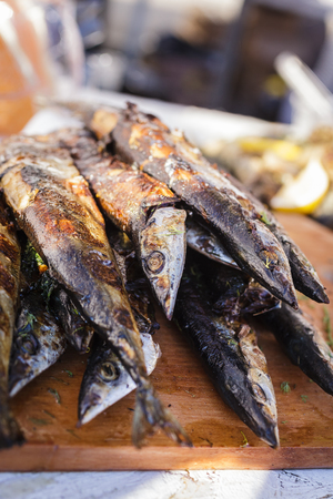 Fresh fried fish on a baking sheet. Street foodの写真素材