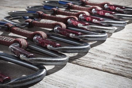 A set of climbing carbines on a wooden table.