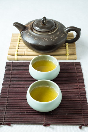 tea set on a table with a bamboo substrateの写真素材