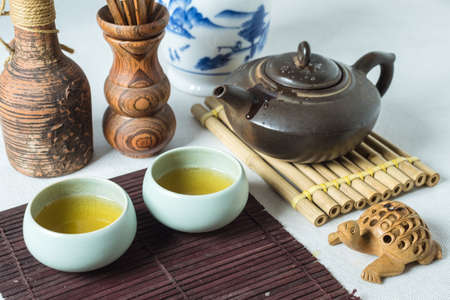 tea set on a table with a bamboo substrateの写真素材