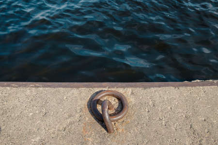 Old vintage marina bollard (bitt) for boats, ships and yachts mooring in marina