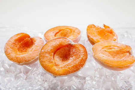 Fresh berries apricots on ice quick freezing close upの写真素材
