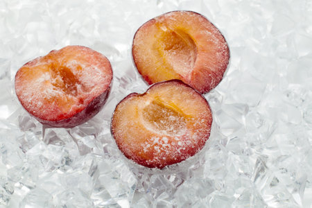 Fresh plum berries on quick freeze ice closeupの写真素材