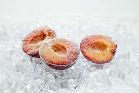 Fresh plum berries on quick freeze ice closeupの写真素材