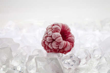 Fresh raspberries on frozen ice close-upの写真素材