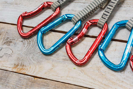 Set of climbing quickdraws on a wooden background. rock climbing equipmentの写真素材