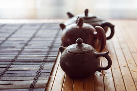 tea set on a table with a bamboo mat. ceramic cupsの写真素材