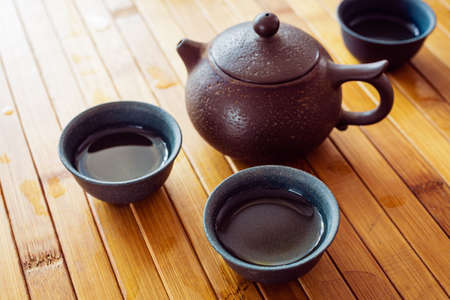 tea set on a table with a bamboo mat. ceramic cupsの写真素材