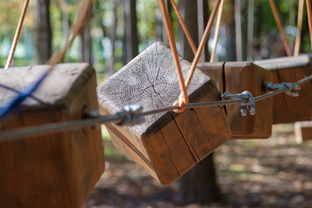 The bridges, ropes and ladders of the Adventure Park are designed for beginners among the tall trees. Adventure climbing in a high rope course. Rope track in the city parkの写真素材