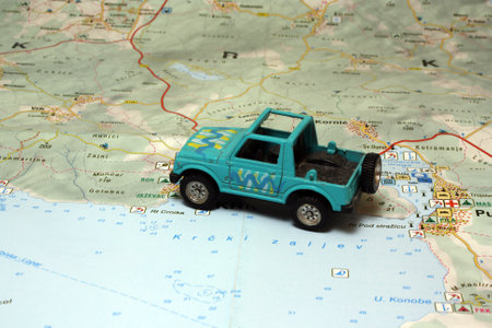 The car model toy and a tourist map in the backgroundの写真素材