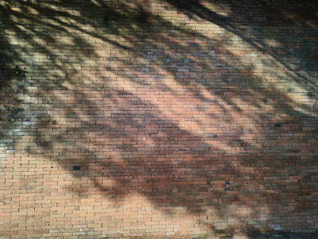 The bricks are arranged neatly and glued with cement to form a wall. looks old and the color is no longer bright, Red brick wall texture background with weathered bricks, cement joints, and an aged,の写真素材