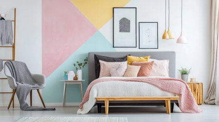 A modern bedroom featuring stylish bed with pastel colored pillows, cozy blanket, and decorative wall art. room has warm and inviting atmosphere, perfect for relaxationの素材