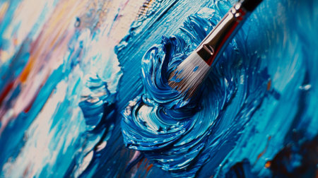 A close-up view of a vibrant blue paint swirl created by a brush on canvas, showcasing the artistic process and texture in a colorful and creative art piece.の素材