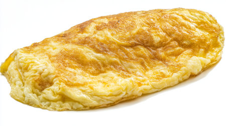 A beautifully cooked golden omelette, fluffy and inviting, perfect for breakfast or a nutritious snack. A simple yet delicious dish ideal for any meal.の素材
