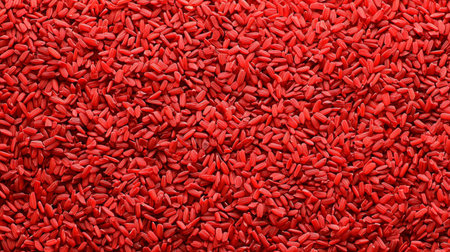 A striking close-up of vibrant red grains fills the frame, showcasing a unique texture suitable for food-related projects, culinary presentations, or healthy lifestyle themes.の素材