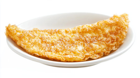 A beautifully plated crispy fried omelet showcases a delightful golden-brown hue, ideal for breakfast or culinary presentations, appealing to all food lovers.の素材
