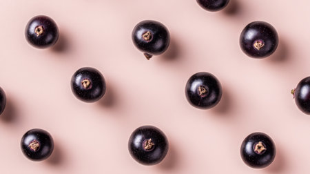 A visually appealing arrangement of fresh blackcurrants on a smooth surface highlights their deep color and texture, perfect for representing health and nutrition themes.の素材