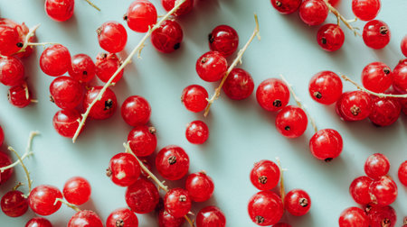 A vibrant display of fresh red berries on a light background, perfect for healthy recipes, food photography, or culinary art showcasing natural beauty and nutrition.の素材