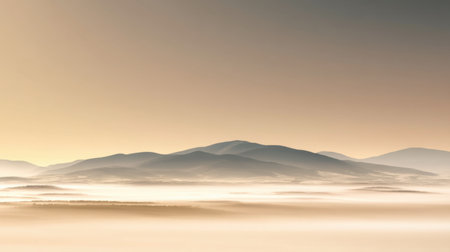 Experience the tranquil beauty of a misty mountain landscape at sunrise, showcasing soft light and serene hills that evoke a sense of peace and exploration.の素材