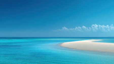 A tranquil beach landscape featuring soft sand and crystal clear water under a bright blue sky. The scene evokes feelings of peace, beauty, and relaxation, perfect for a getaway.の素材