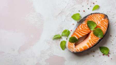 An aesthetic arrangement featuring a fresh salmon fillet adorned with green leaves and pink peppercorns, perfect for culinary and healthy eating themes.の素材