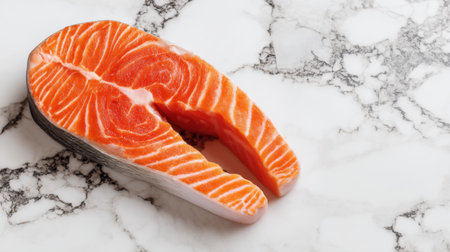 A beautifully presented salmon steak sits on a sleek marble countertop, showcasing its vibrant color and texture. Perfect for culinary projects and food photography.の素材