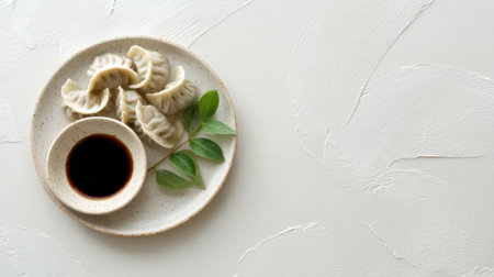 Enjoy a beautifully arranged plate of freshly steamed dumplings accompanied by soy sauce. This image captures the essence of Asian cuisine with a touch of elegance.の素材