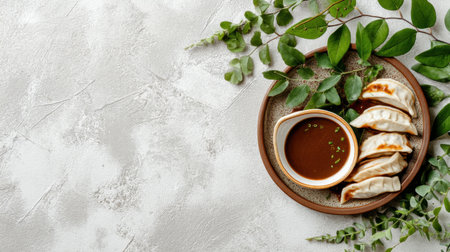 Delight in an arrangement of freshly steamed dumplings on a rustic plate, accompanied by rich dark soy sauce and complemented by vibrant green herbs. Perfect for food lovers!の素材
