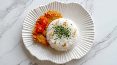 A beautifully arranged plate featuring crispy fried chicken, fluffy steamed rice, fresh cherry tomatoes, and a sprinkle of green herbs. Perfect for food lovers.の素材