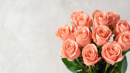 A beautiful bouquet of fresh peach roses arranged elegantly on a soft gray background, ideal for various occasions like weddings, gifts, or home decor.の素材