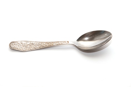  metal spoon with ornamented handle on white backgroundの写真素材
