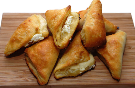 Pastry buns with cheese filling on a cutting boardの写真素材