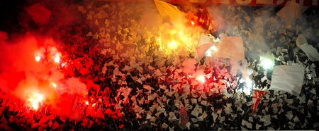 SERBIA, BELGRADE - APRIL 12, 2014: Soccer or football fans celebrating goal using pyrotechnics during Serbian championship soccer game between Red Star Belgrade and Cukarickiのeditorial素材