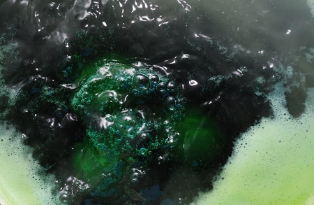 Dark green boiling waterの写真素材
