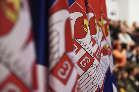 Several  flags of Serbia in a raw, with focus on coat of armsの写真素材