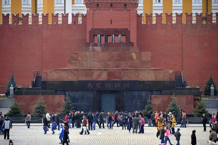 MOSCOW, RUSSIA - MARCH 23, 2014: Tourists walking in front of the Mausoleum of Lenin and Kremlin wall on Red Square, Moscow, Russia on March 23, 2014のeditorial素材