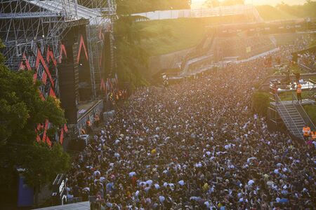 Novi Sad, Serbia - 04 July 2019: Visitors of Exit Festival dance at Dance Arena during sunrise. The...