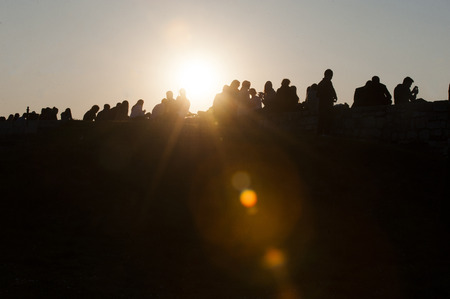 BELGRADE, SERBIA - MARCH 14, 2014: People enjoy spring day by sitting on the wall of Kalemegdan fortress during sunsetのeditorial素材