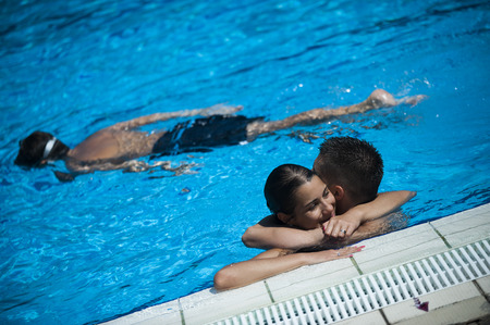 BELGRADE, SERBIA - AUGUST 11, 2015: Young couple hug in water, cooling in the pool Tasmajdan in center of Belgradeのeditorial素材