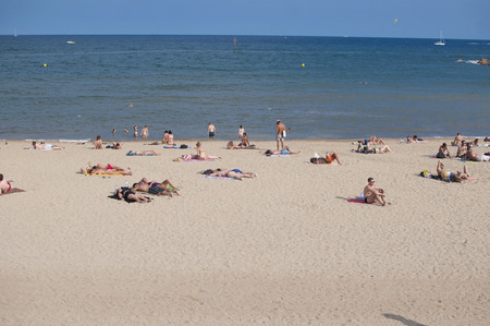 BARCELONA, SPAIN - SEPTEMBER 13, 2014: View of people relaxing on the Barceloneta beach, Mediterranean coastlineのeditorial素材