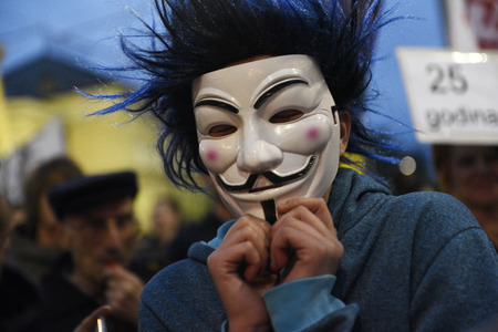 BELGRADE, SERBIA - 18 APRIL 2017: Young man with an anonymous mask attends protest against regime of Aleksandar Vucic, elected for president in Belgrade, Serbiaのeditorial素材