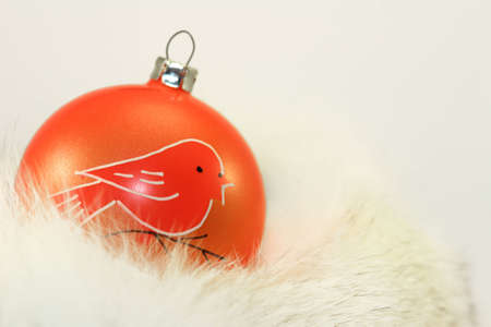 Orange Christmas Bauble on White Fur.の写真素材