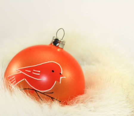 Orange Christmas Bauble on White Fur.の写真素材