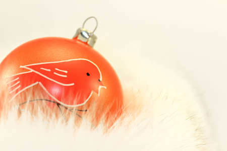 Orange Christmas Bauble on White Fur.の写真素材