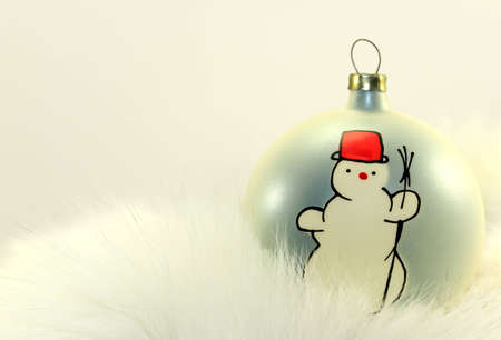Christmas Bauble with Snowman on White Fur.の写真素材