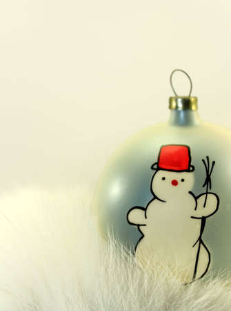 Christmas Bauble with Snowman on White Fur.の写真素材