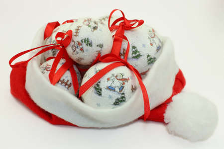 Christmas Baubles with Red Ribbonons in Santa Claus Hat.の写真素材