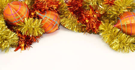 Orange-Yellow Christmas Decorations and Orange-Yellow Tinsel on White Background.の写真素材